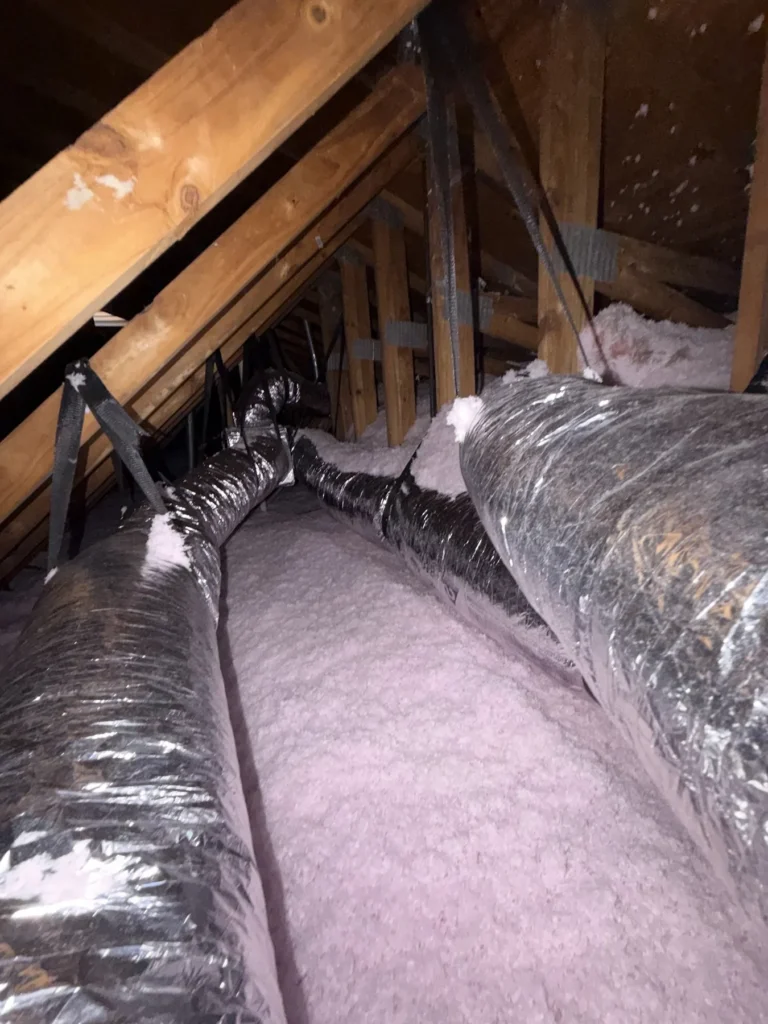 Attic ductwork over pink insulation