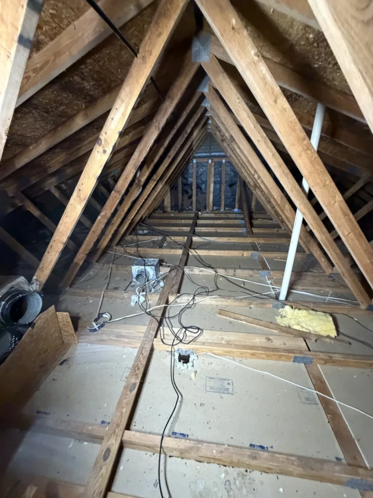 Attic insulation between the joists during an insulation check-up