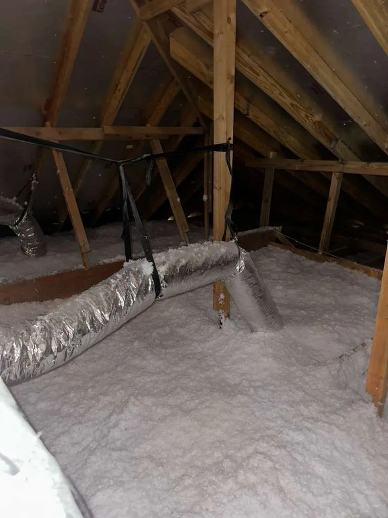 Attic with fresh blown-in insulation after cleanup