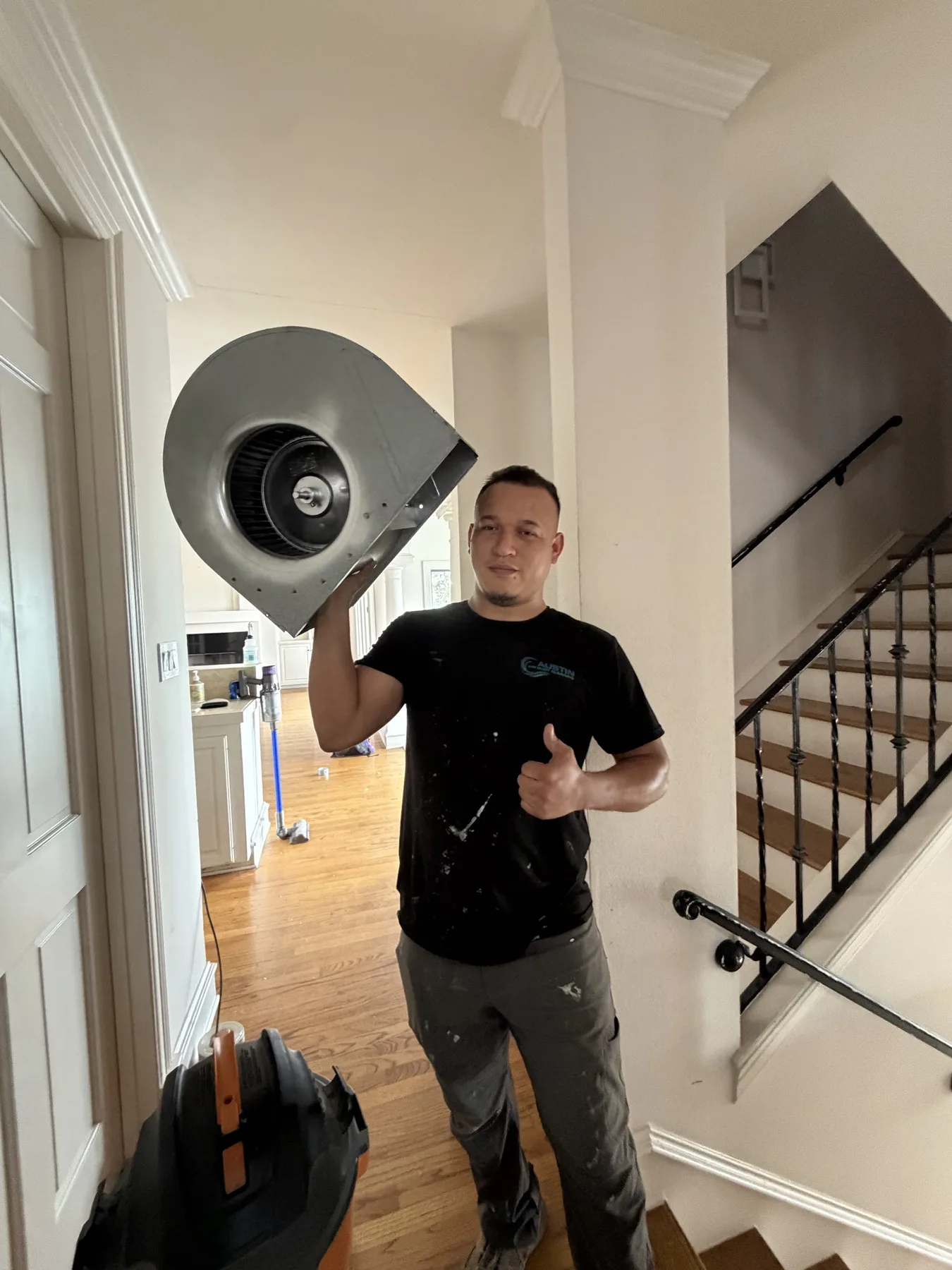 Austin Air Duct Cleaning technician holding a cleaned blower wheel in a customer home