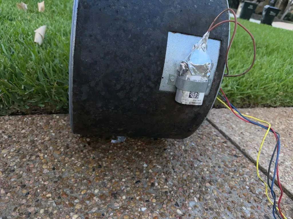Blower assembly removed from the air handler and taken outside for cleaning