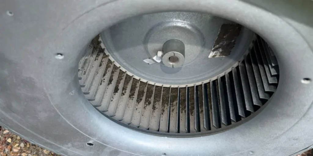 Blower wheel removed from an air handler for cleaning