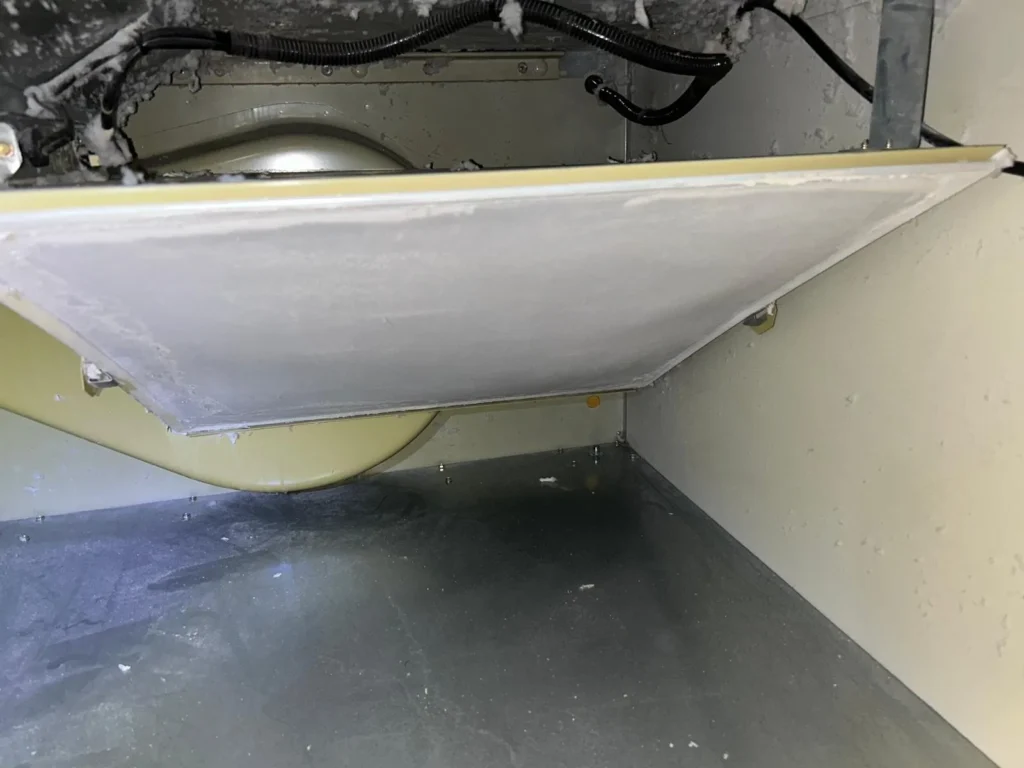 Commercial dryer lint chamber partly cleaned during the work