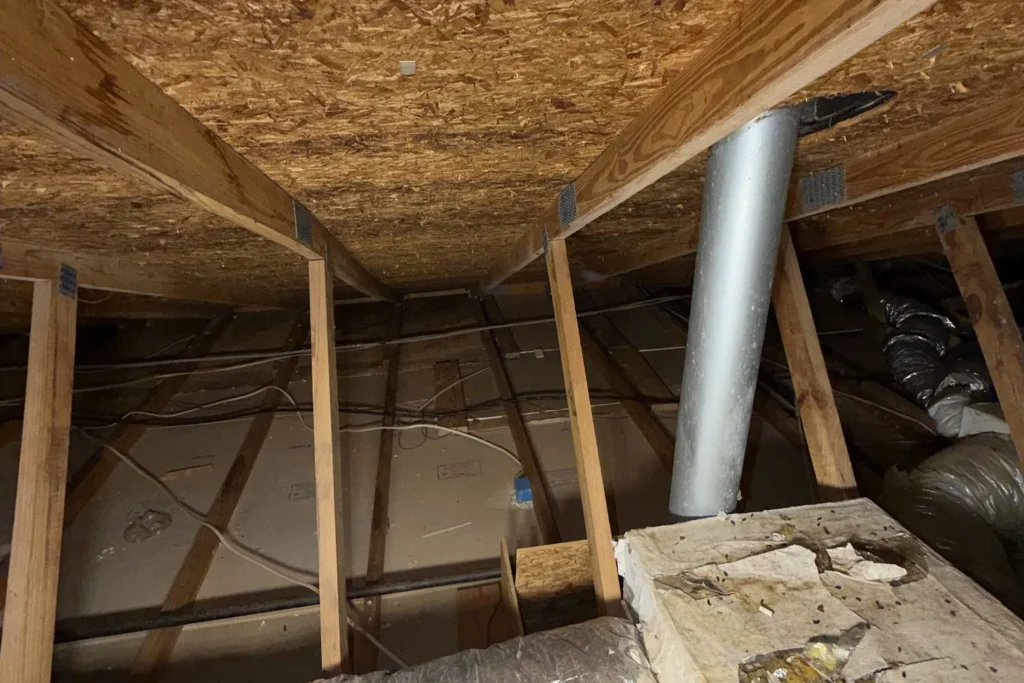 Debris in the attic before cleanup – Attic Sanitization & Cleanup