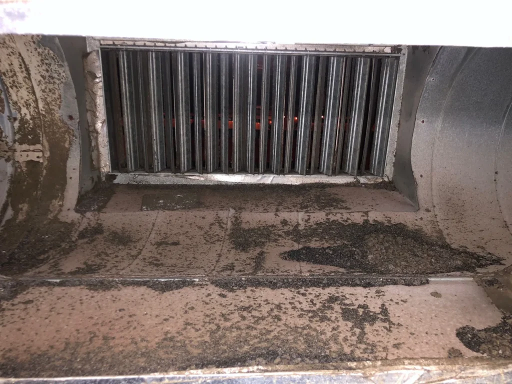Debris spread across the floor of a commercial air plenum
