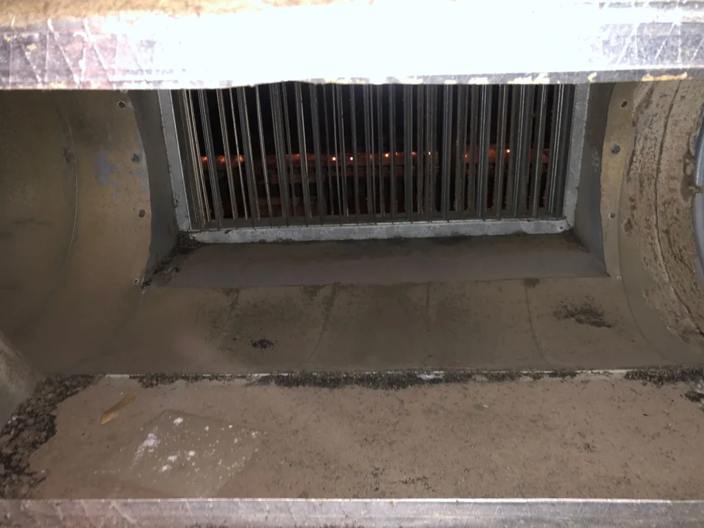 Dust and debris settled in a commercial supply plenum