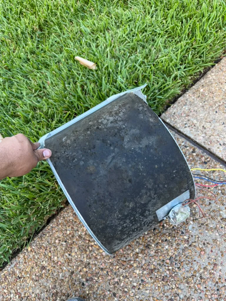 Dust-coated HVAC access panel removed from a system