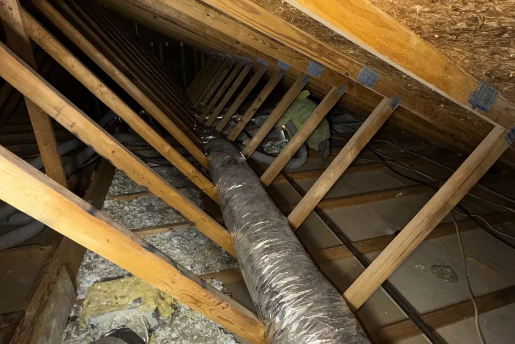 Flexible ductwork running across an Austin attic