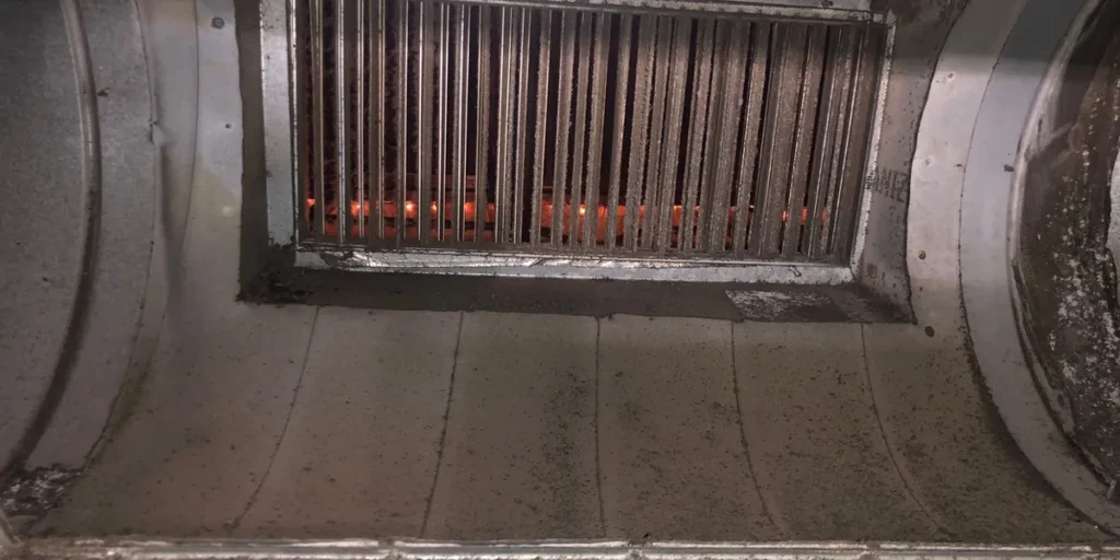 Inside a commercial supply plenum with a damper grille