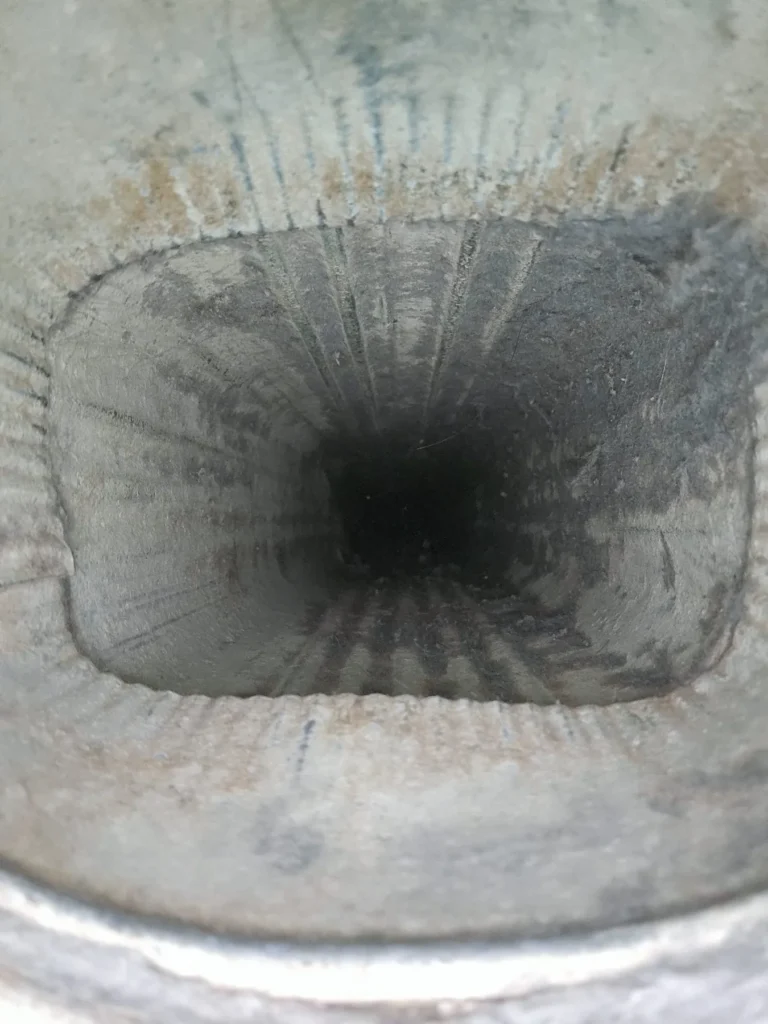 Lint coating the inside of a dryer vent before cleaning