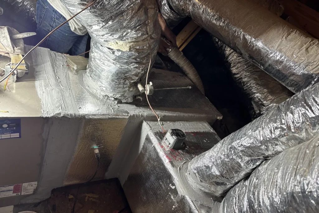 Newly installed supply plenum and flexible ducts in an attic