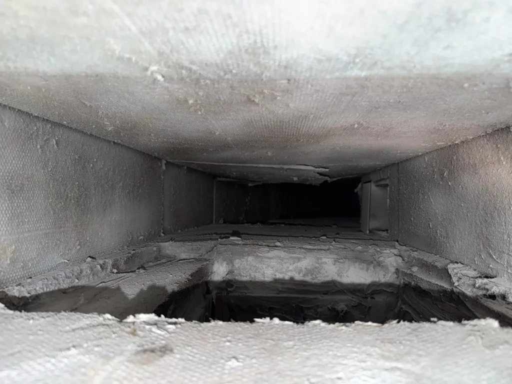 Sheet metal supply trunk with settled dust (Round Rock area)