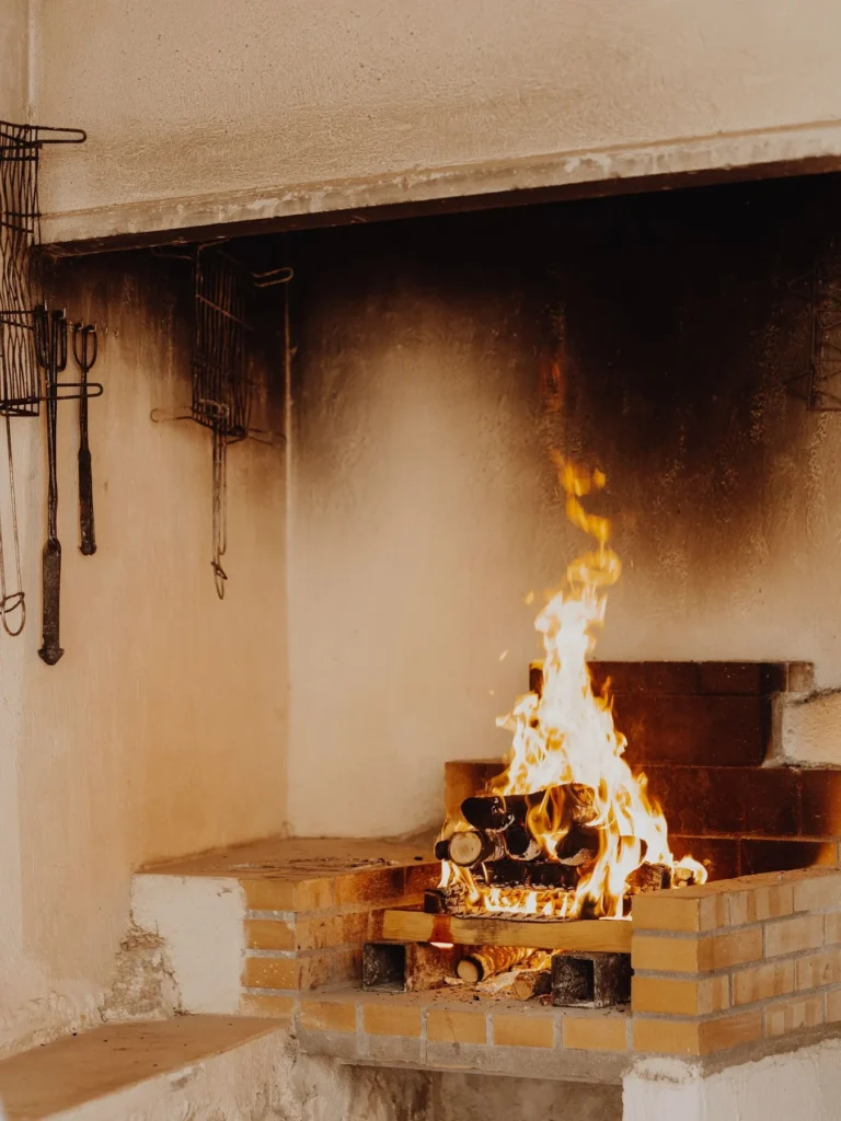 Sooty fireplace firebox with a fire burning