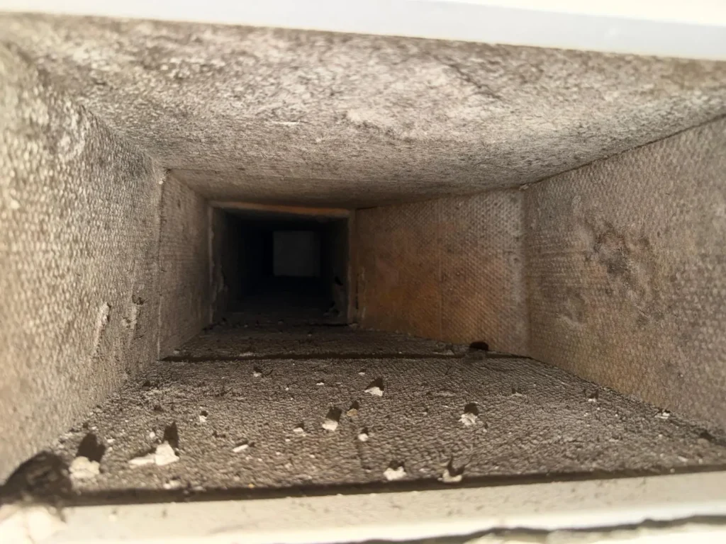 Supply trunk with debris before cleaning