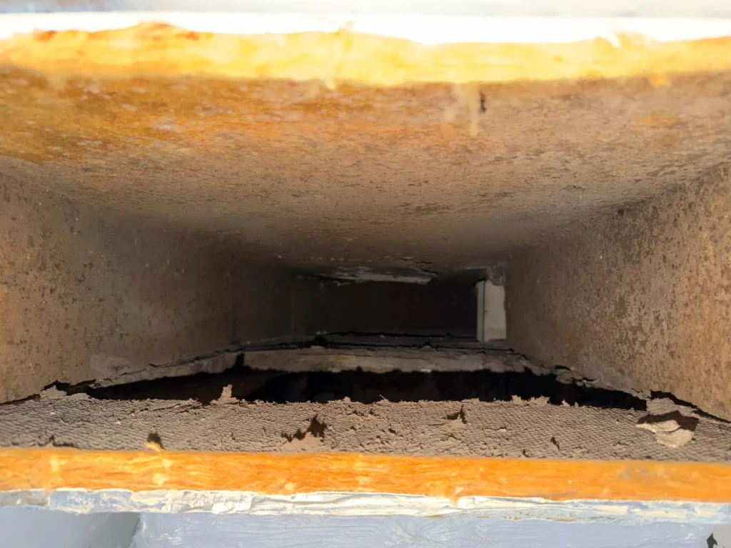 Supply trunk with dust settled along the bottom before cleaning