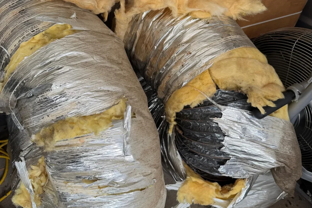 Torn and crushed flexible ducts removed from an attic